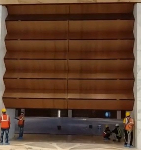 Skyfold Classic vertical retractable acoustic wall being installed in a marble lobby